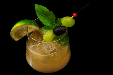 Cocktail drink on the rocks with fruit isolated
