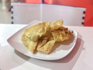 Pangsit goreng — crispy fried wontons filled with savory meat, a popular Indonesian-Chinese snack or side dish served with dipping sauce. Cisauk, BSD - April 20, 2025.