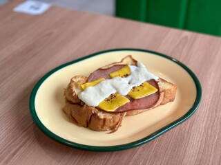 Toast with ham and cheese topped with creamy carbonara sauce—rich, savory, and indulgent, perfect for a comforting meal. April 6. 2025 - Cisauk, Indonesia.