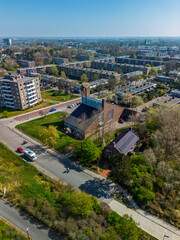 Aerial view of a residential neighborhood with a church at the center, surrounded by apartment...