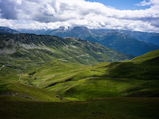 Naklejka premium Sweeping view over alpine pastures and rugged peaks, French Alps