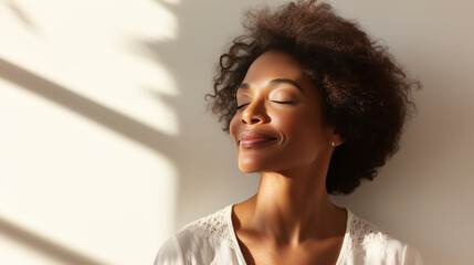 A graceful woman in white closes her eyes and smiles softly as sunlight touches her face, capturing a sense of inner peace and mindful relaxation sunlit face, gentle smile, feminin