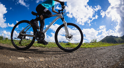 Fototapeta premium Woman riding mountain bike in the beautiful mountains