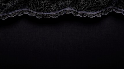 Dark fabric detail A delicate, scalloped lace edge adorns textured, soft material. Rich depth, elegant texture