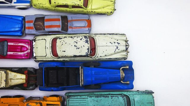Retro toy cars are in a traffic jam, stop motion on a white background 