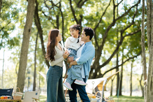 Happy asian family picnic in park, weekend lifestyle outdoors.