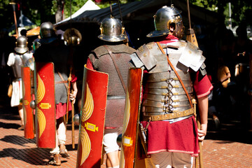 detail of roman armor and scutum shields from behind, roman army reenactment event