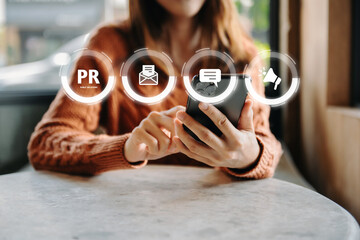 PR, Public relations concept. hands using laptop and tablet with public relations icon for...
