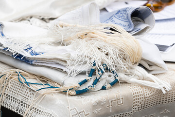 A tradition prayer shawl worn by Jewish men with blue, techelet tzitzit strings.