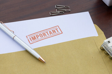 Crucial Message: Important Paper Emerging from Envelope with Pen on Desk