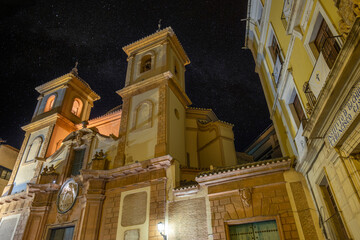Facade of the baroque church of San Juan de Dios in Murcia, Spain, illuminated at night by a starry...