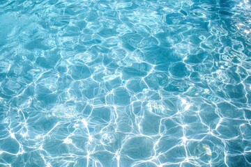 Fototapeta premium Sparkling turquoise water surface reflecting sunlight.