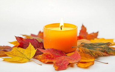 Single Lit Candle Surrounded by Autumn Leaves Isolated on white background.