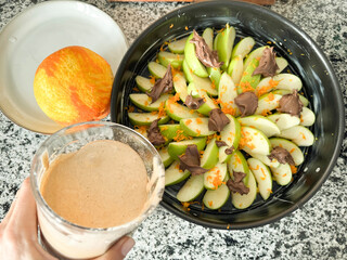 Fresh green apples topped with nut spread and served with a creamy drink at home kitchen