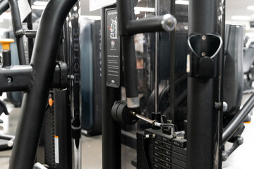 sstkWellness captures the essence of modern fitness with this striking image of a mechanical strength training machine loaded with weight plates, highlighting the synergy between structured physical

