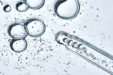 The texture of a serum or cosmetic gel with a pipette. Angle from below.