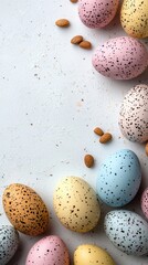 Obraz premium Pristine White Canvas with Vibrant Speckled Easter Eggs and Almonds for a Festive Spring Celebration