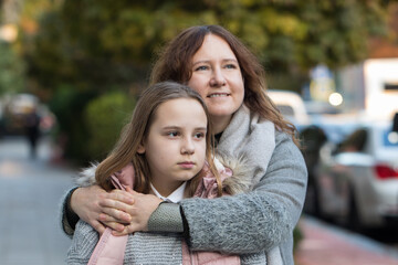Happy woman hugging child. Mother and daughter together. Childhood, happiness, love and family concept