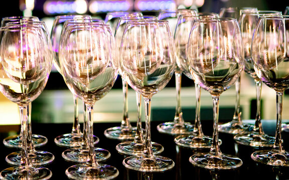 Elegant wine glasses arranged on a bar counter, ready for a special occasion or celebration at an upscale venue