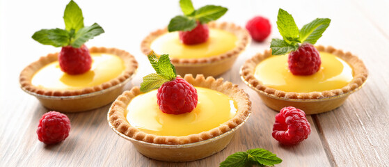 Delicious red strawberry and white cream top these sweet gourmet cupcakes