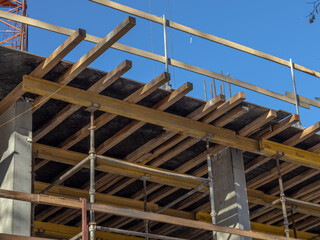 Equipment for construction. The frame of a building under construction. The structure of the building. The construction of the supporting reinforced concrete pillars of the house.