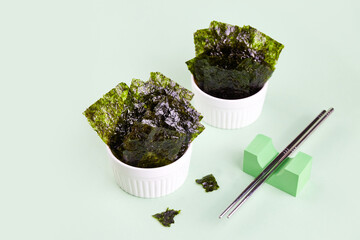 Crispy nori seaweed on bowl. Traditional Japanese dry seaweed sheets.