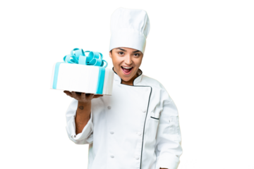 Woman pastry chef with a big cake with surprise and shocked facial expression