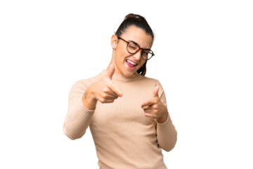 Young beauty woman over isolated chroma key background pointing to the front and smiling