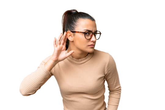 Young beauty woman over isolated chroma key background listening to something by putting hand on the ear