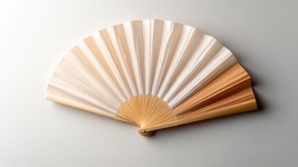 This image showcases an elegant fan featuring delicate color gradients, emphasizing the subtle beauty of craftsmanship and design in a minimalist aesthetic.