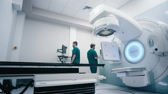 Medical specialists prepare the equipment for radiation therapy in a modern clinic before the procedure. The concept of medical technology and therapy for cancer patients.
