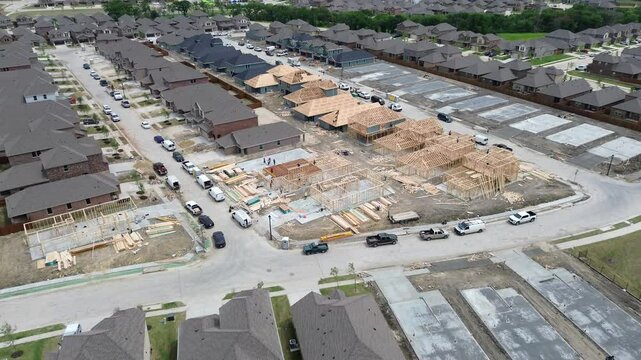 Custom home builder working on home building wooden house construction, site preparing land, compact exposed soil, added gravel to create flat, stable base slab foundation in Princeton, flyover