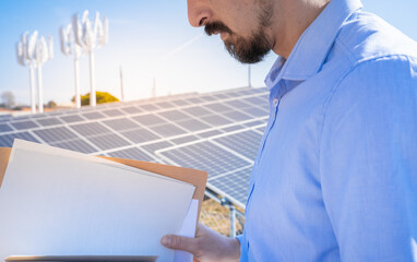 A professional evaluates solar panel installations, promoting renewable energy solutions for efficiency