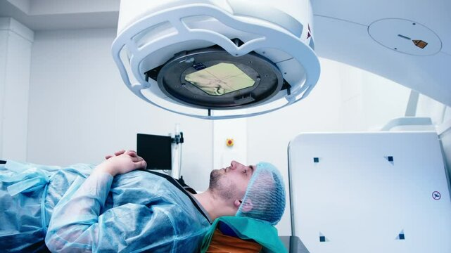 A young man undergoes radiation therapy for cancer at a state-of-the-art ocncology center. Concepcion of medical technology and theropy for cancer patients.