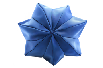 Artistic depiction of a meticulously folded blue fabric star on black background