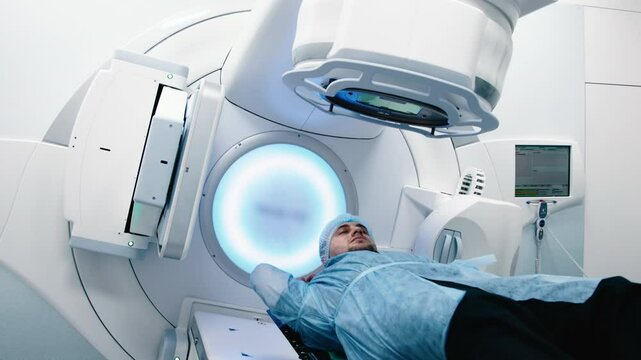 A young man undergoes radiation therapy for cancer at a state-of-the-art ocncology center. Concepcion of medical technology and theropy for cancer patients.