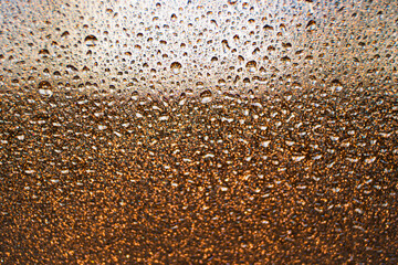 background texture for background brown color with shimmer elements and flowing drops on glass, with overflows and bokeh, beautiful bright background with overflows and gradient