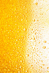 background texture for background bright orange, yellow, sunny color, peach color with shimmering elements and flowing drops on glass, beautiful bright background with overflows and gradient