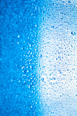 background texture for background bright blue water and sea with shimmering elements and flowing drops on glass, beautiful bright background with iridescent and gradient