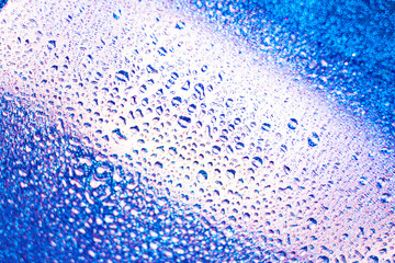 background texture for background bright blue water and sea and purple with shimmering elements and flowing drops on glass, beautiful bright background with overflows and gradient