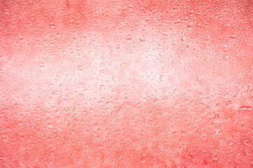 background texture for background bright pink, peach, orange color with shimmers and flowing drops on glass, beautiful bright background with overflows and gradient