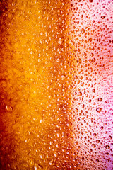 background texture for background bright pink, peach, orange color with shimmers and flowing drops on glass, beautiful bright background with overflows and gradient