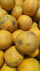 Close up pile of tasty fresh oranges sold at the market as a background.
