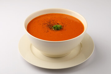 bowl of tomato soup with parsley