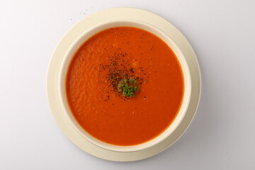 bowl of tomato soup with parsley