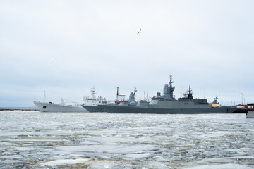 Military ships docked at harbor during winter season in the city of Kronstadt, Russia - March 06, 2025