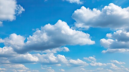 Fototapeta premium Beautiful clear blue sky with white clouds in background, suitable for nature landscape in summer, spring or autumn on sunny day. Ample 2/3 space for text.