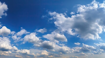 Obraz premium Beautiful clear blue sky with white clouds in background, suitable for nature landscape in summer, spring or autumn on sunny day. Ample 2/3 space for text.