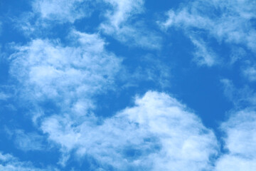 Bright Blue Sky with Soft White Clouds for Background and Design