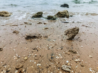 Tranquil Rocky Seaside with Overcast Sky and Gentle Waves